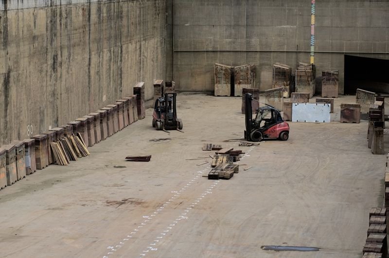 Warehouse interior with racking, pallets and forklifts